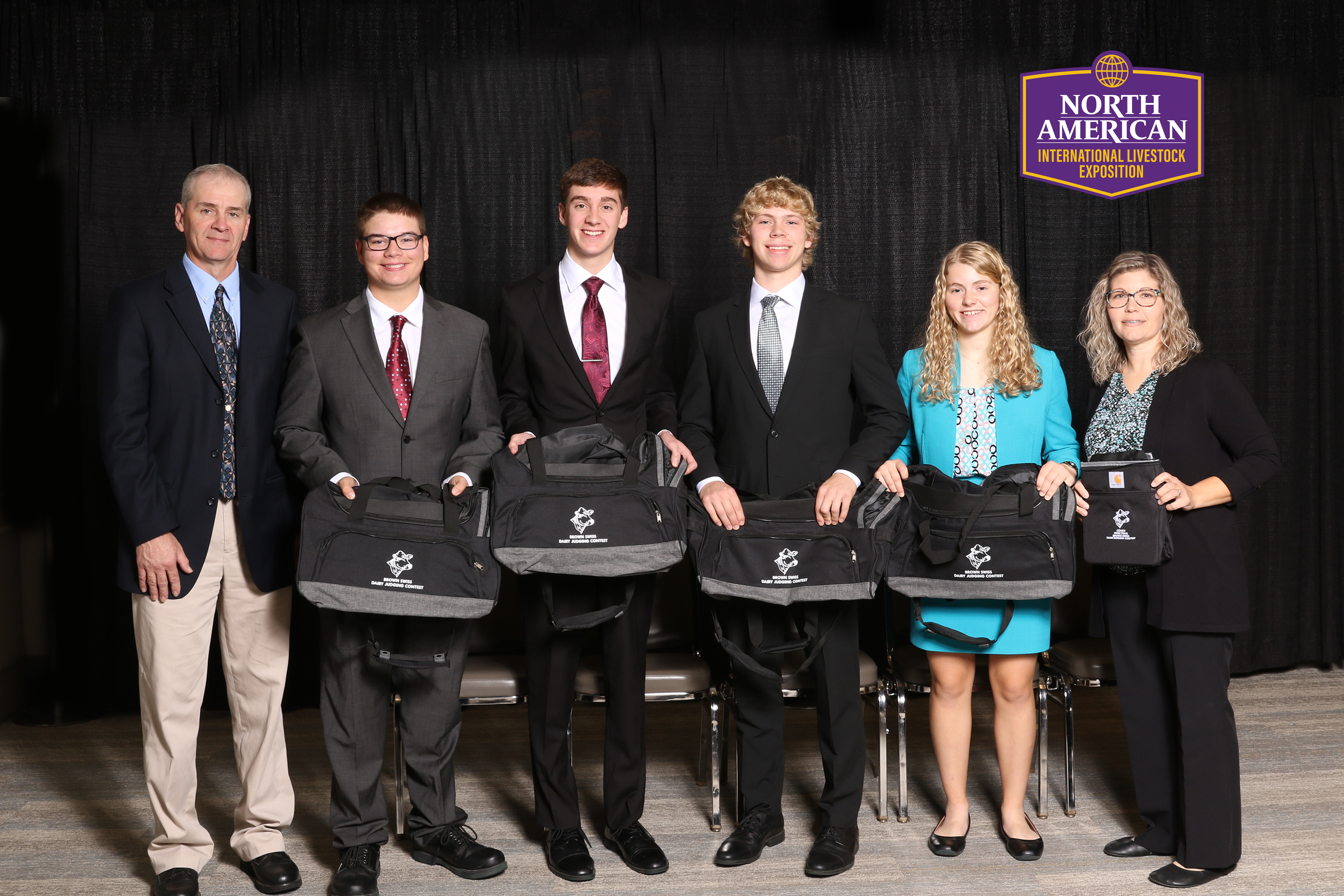 teenagers holding duffle bags