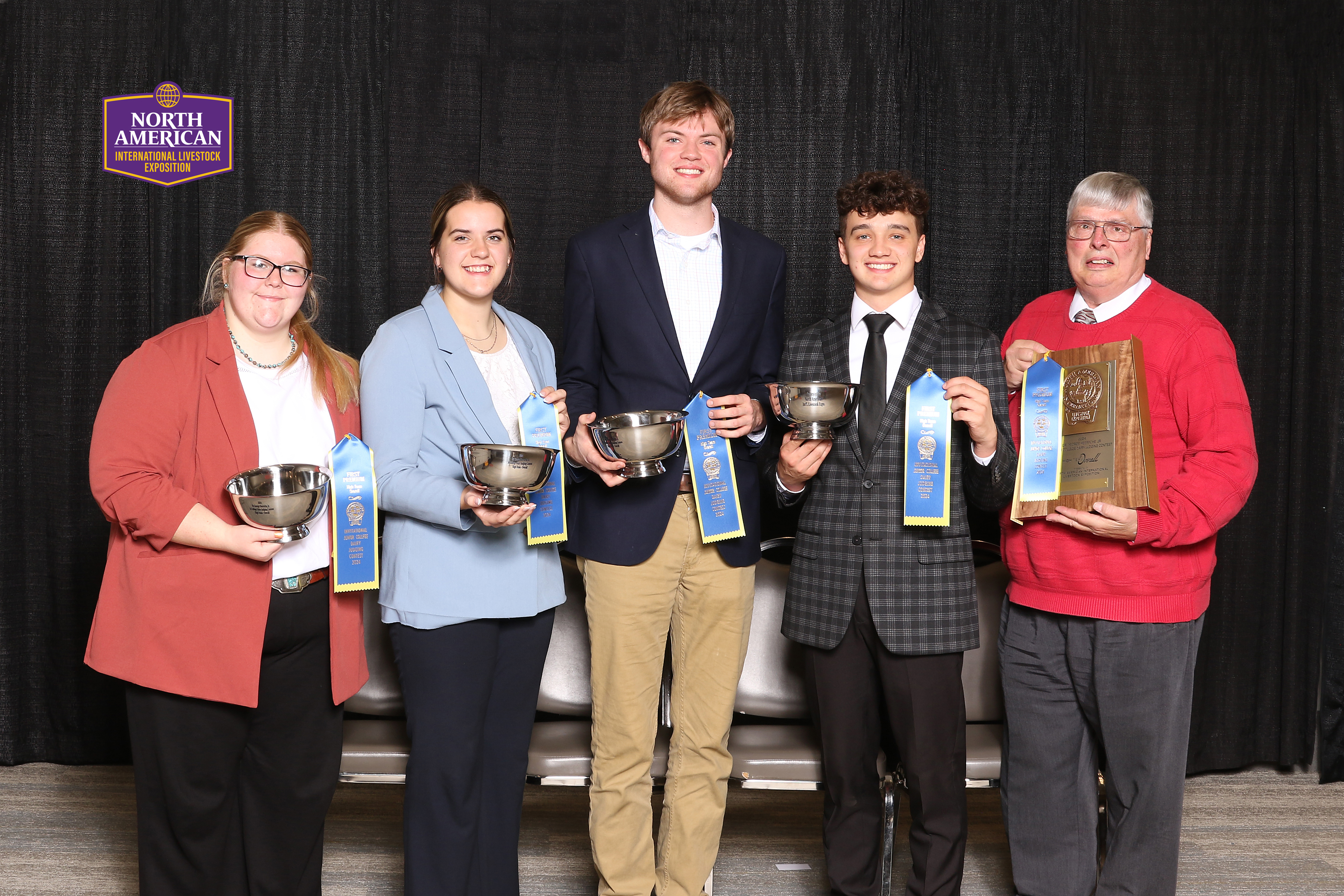 teenagers holding cups and ribbons