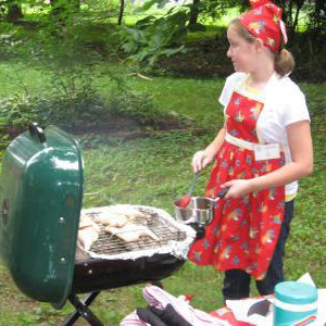 A child grills chicken