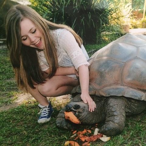 Girl Playing With a Turtle
