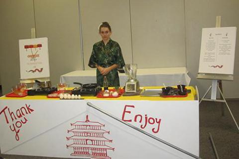 A person stands at an Asian-style table for egg preparation